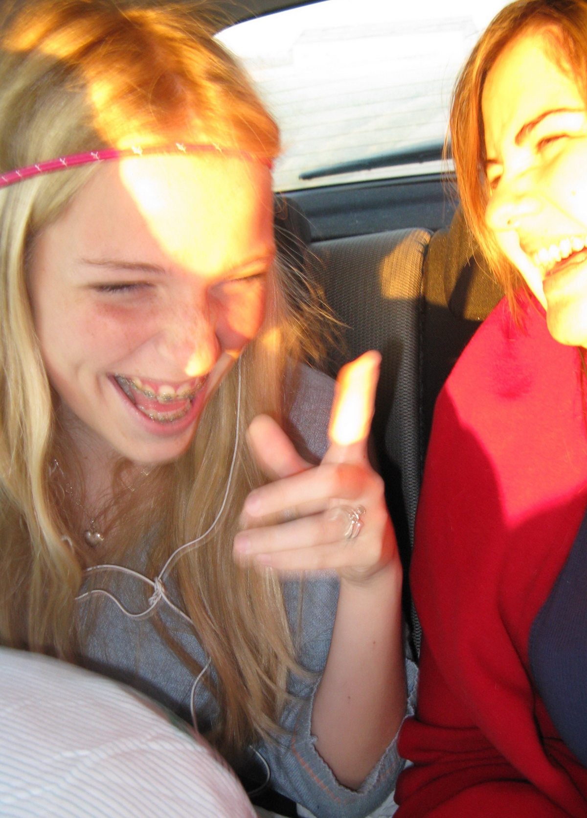 Ida sandau and leah salazar laughing in a car