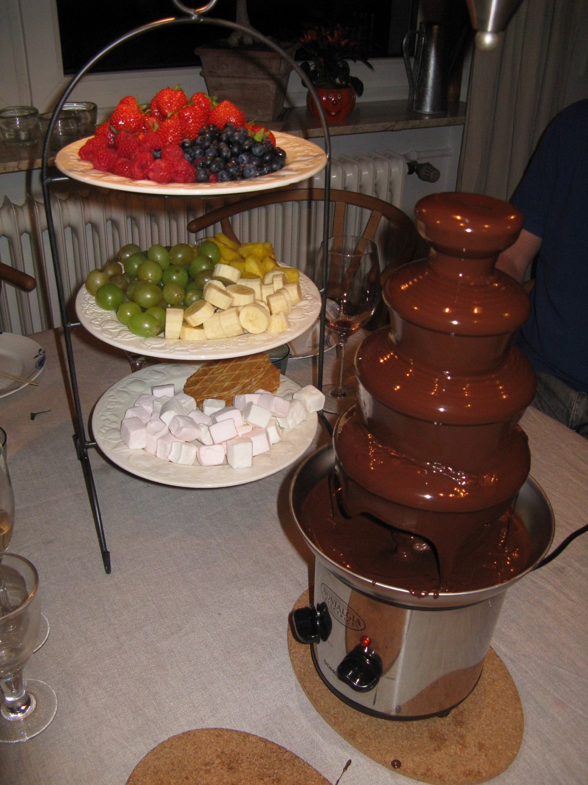 raspberries, blueberries and stawberries and chocolate fountain