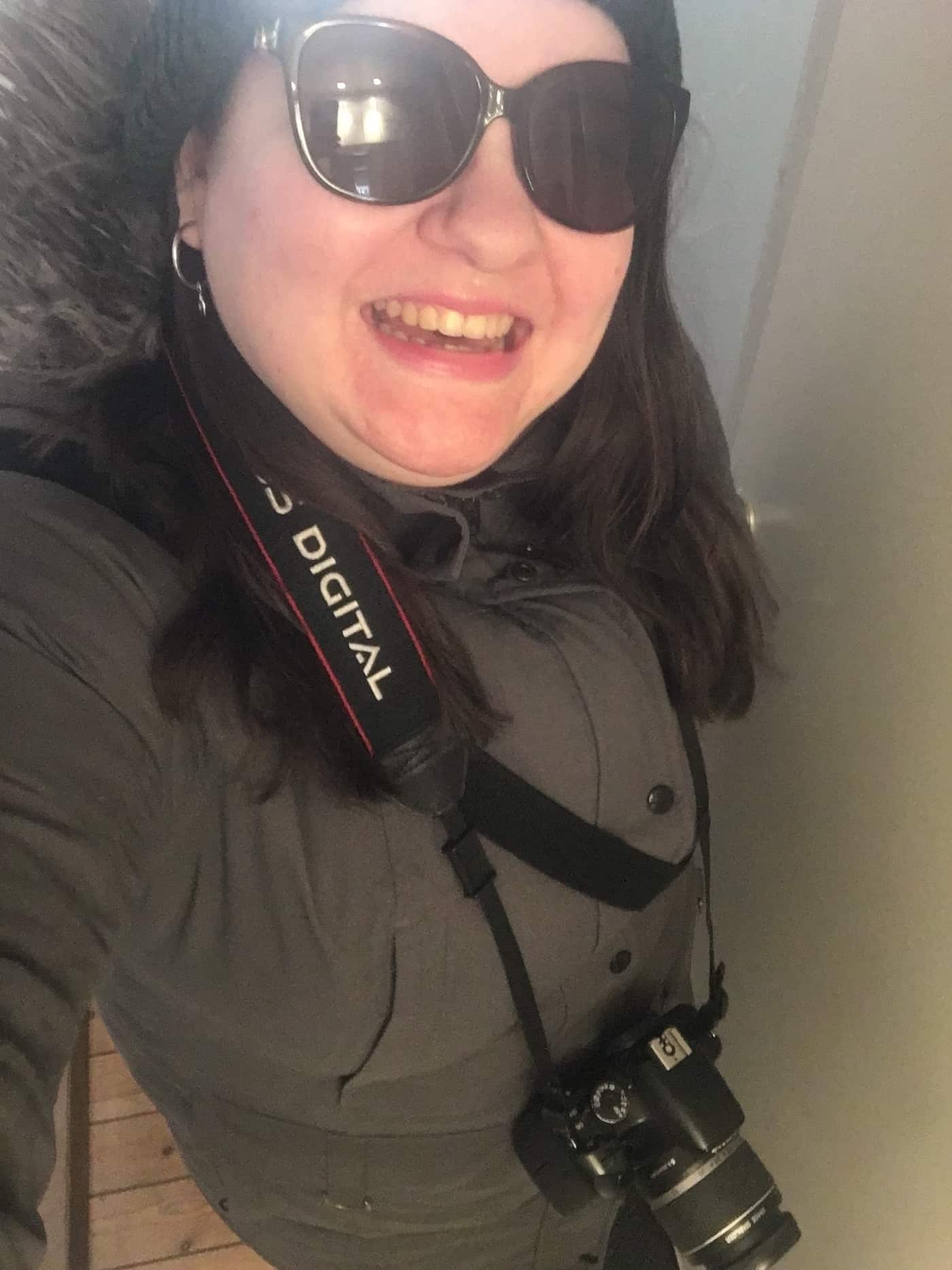 Leah in sunglasses and camera around neck march 2020