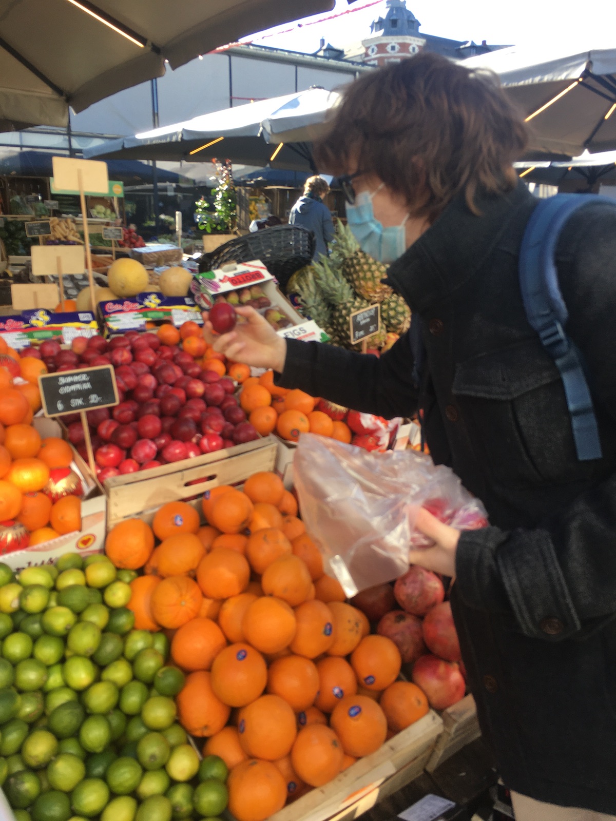 Matt picking some fresh plums at torvehallerne in copenhagen