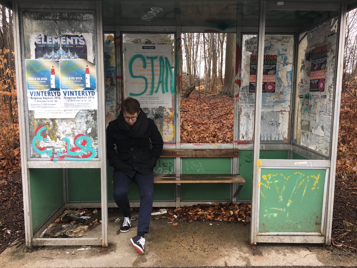 matthew-ross-waiting-at-bus-stop-denmark